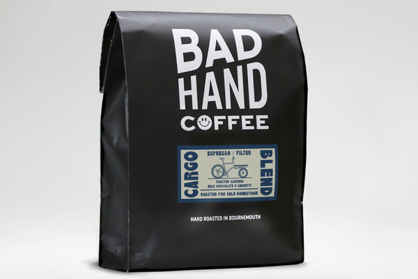 Bad Hand Coffee - One kilogram bag of Cargo Blend coffee roasted with taste notes of toasted almonds, milk chocolate, and amaretto. Suitable for espresso and filter brewing.