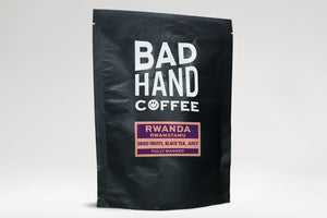 Bad hand coffee - Two fifty gramme postal bag of Rwanda Rwamatamu, single origin coffee, with taste notes of dried fruits, black tea and juicy. Hand roasted and fresh to order. Available as whole bean or we can grind it to suit your home brew method. These bags are 100% paper and home compostable.