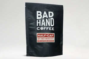 Bad Hand Coffee - Two fifty gramme postal bag of Half-Caf, low caffeine session coffee - taste notes: soft, sweet and biscuity. Hand roasted and fresh to order. Available as whole bean or ground to your home brew method. These bags are 100% paper and home compostable.